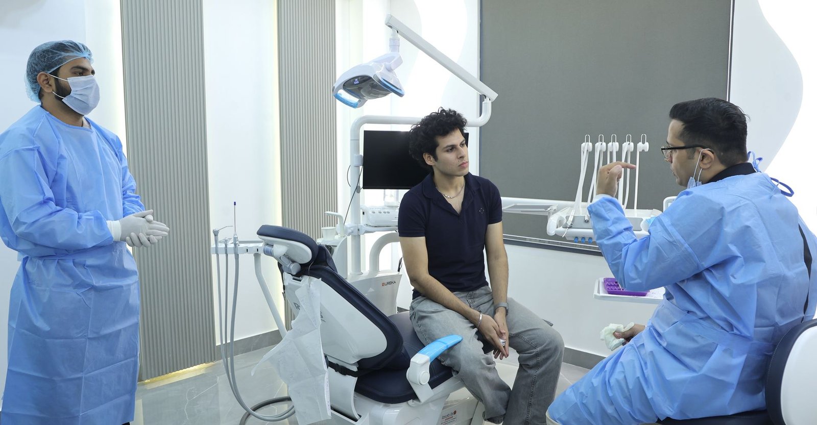 Patient in the treatment chair with the clinical team at Carat Smiles, South Delhi